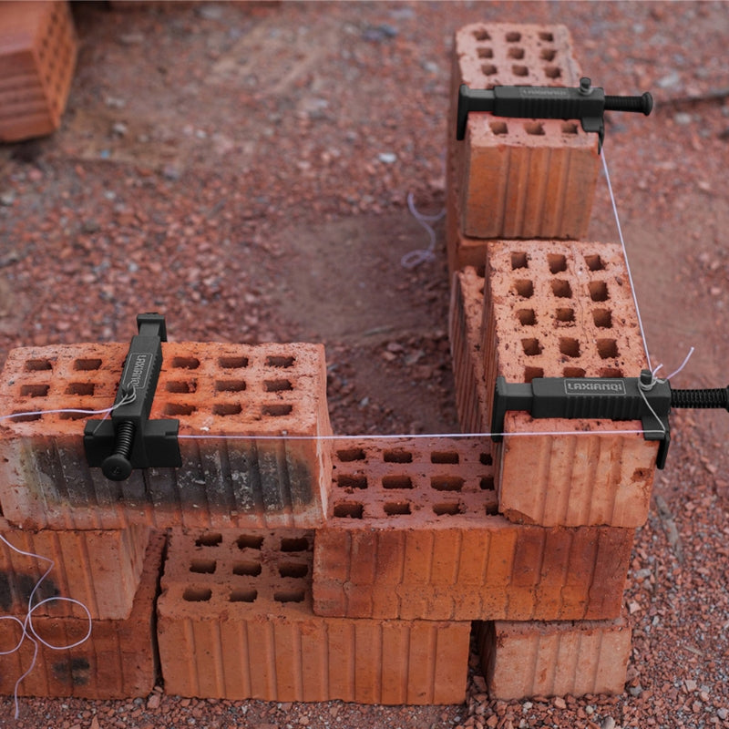 A close-up of a brick liner puller tool used to extract wire from bricks on a reddish gravel surface.