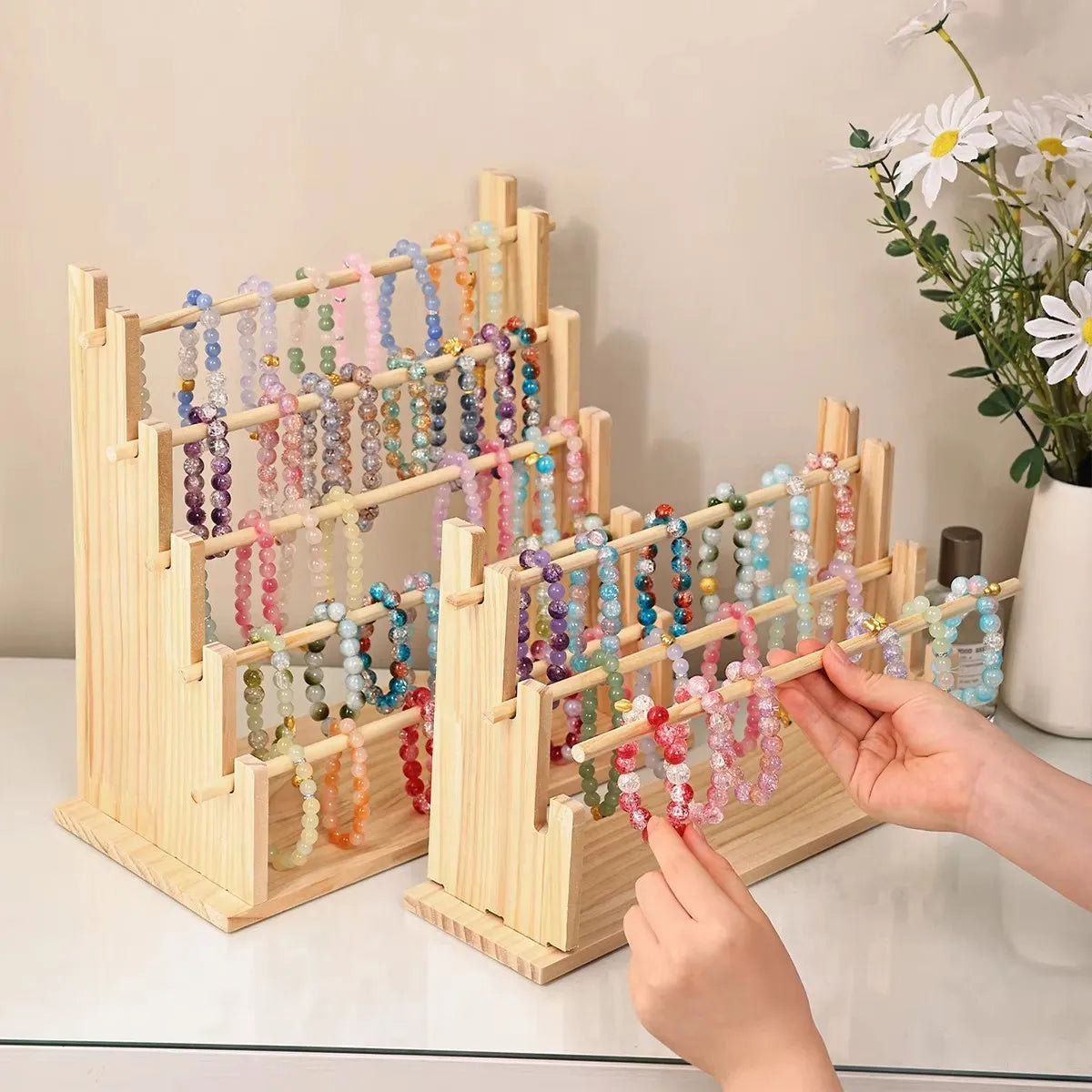 Solid wood ladder jewelry organizer with multiple storage tiers displaying colorful beaded necklaces