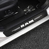 Black carbon fiber door sill protectors for a vehicle, showing the RAM branding.
