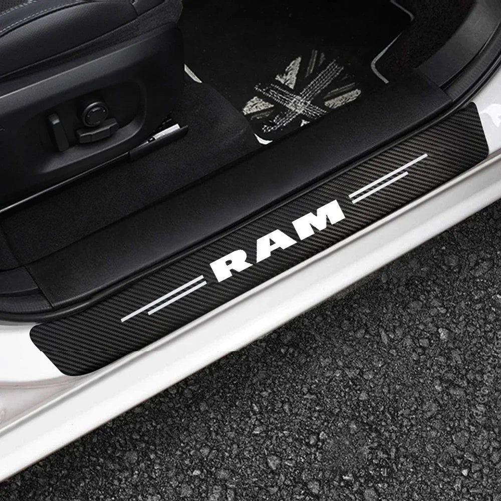 Black carbon fiber door sill protectors for a vehicle, showing the RAM branding.