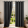 Black blackout curtain panels with grommet top hanging in a doorway