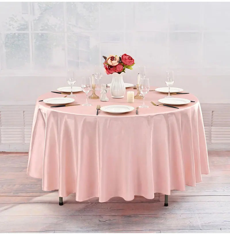 Elegant pink satin round tablecloth set for weddings and events with floral centerpiece