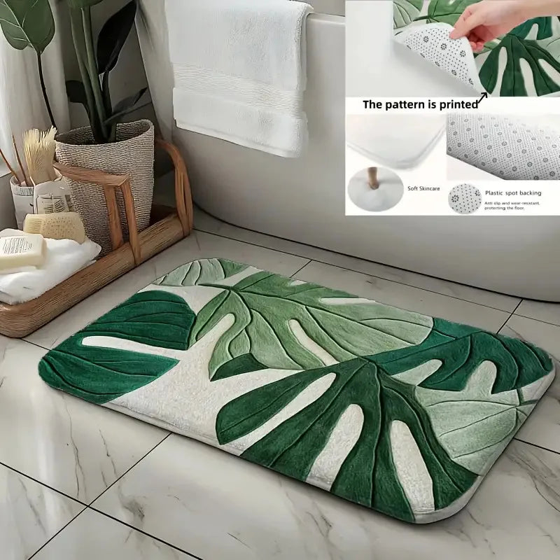 A tropical green leaf print non-slip area rug placed on a tiled floor next to a bathroom sink.