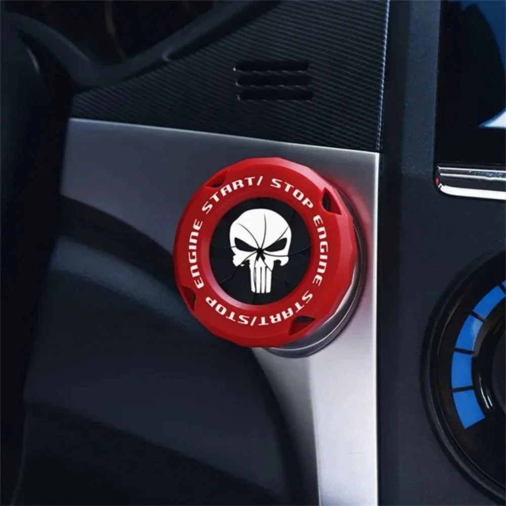 A close-up of a red and black rotating protective cover for a car ignition start button.