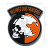 Black embroidered patch featuring a white skull silhouette of a foxhound head on an orange background with yellow text.