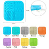 A set of silicone licking pads in various colors including blue, pink, purple, yellow, green, gray, brown, and orange.