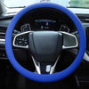 A blue silicone steering wheel cover for a car, showing the steering wheel and dashboard controls.