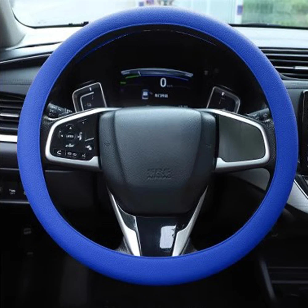 A blue silicone steering wheel cover for a car, showing the steering wheel and dashboard controls.