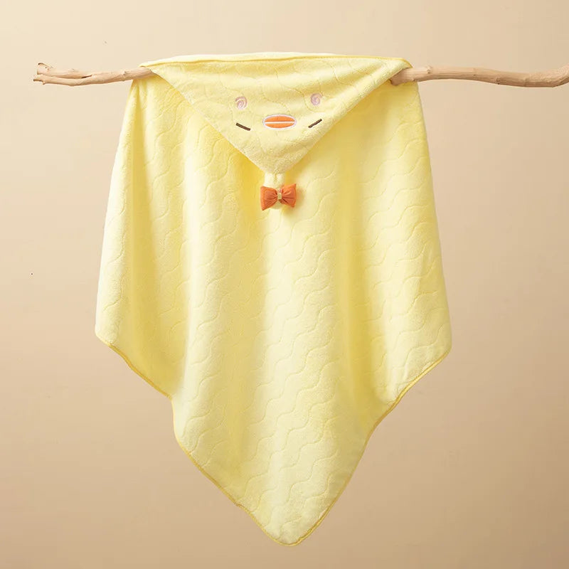 Yellow hooded baby bathrobe towel with a cartoon duck face design hanging on a wooden branch