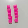 A set of ten bright pink glow-in-the-dark tire valve caps arranged in two vertical columns.