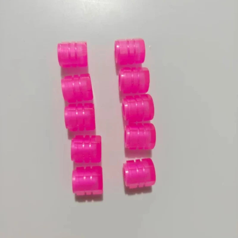 A set of ten bright pink glow-in-the-dark tire valve caps arranged in two vertical columns.