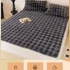 A dark gray quilted velvet pillowcase with a textured surface is shown on a bed, emphasizing warmth for winter.