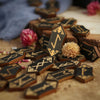 A collection of wooden rune stones and divination tools scattered on a light surface.
