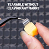 A hand applies a double-sided transparent adhesive patch to a surface, demonstrating its tearable quality.