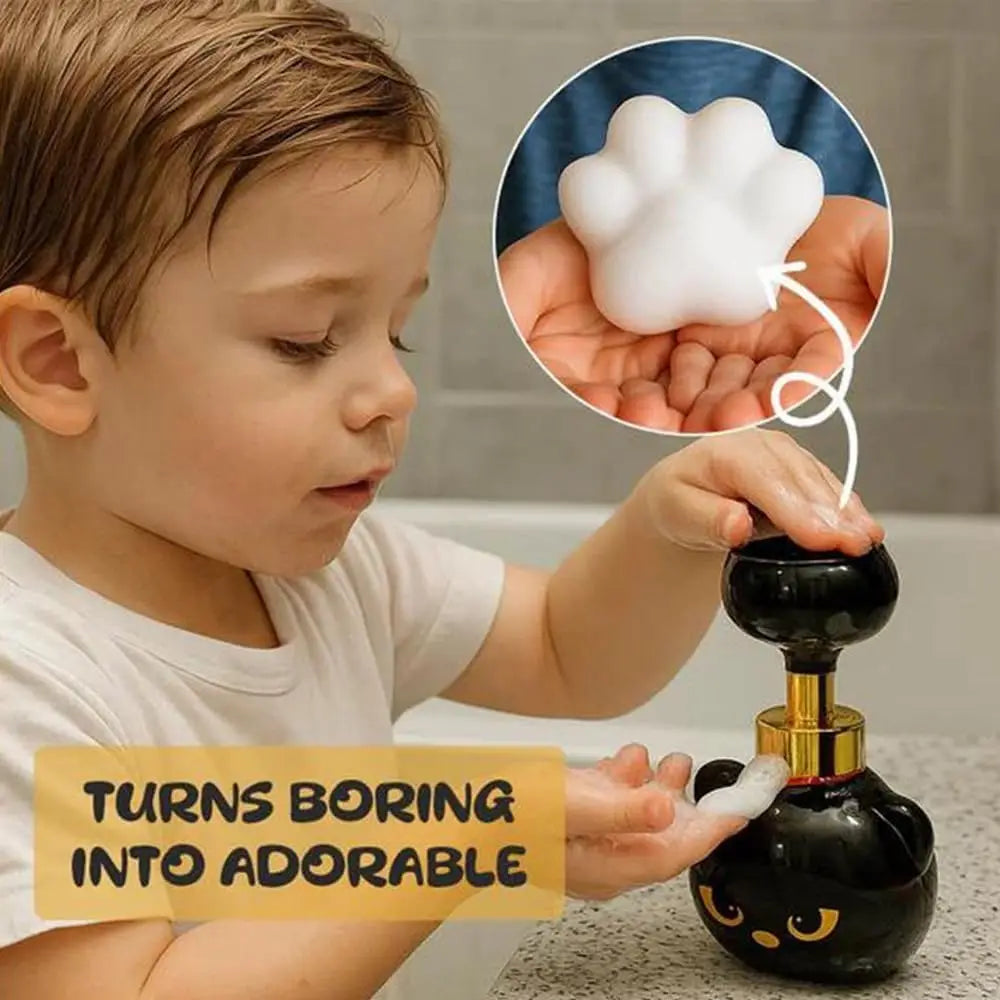 A child is holding a black foam cat paw soap dispenser, with an inset showing the soft white foam texture.