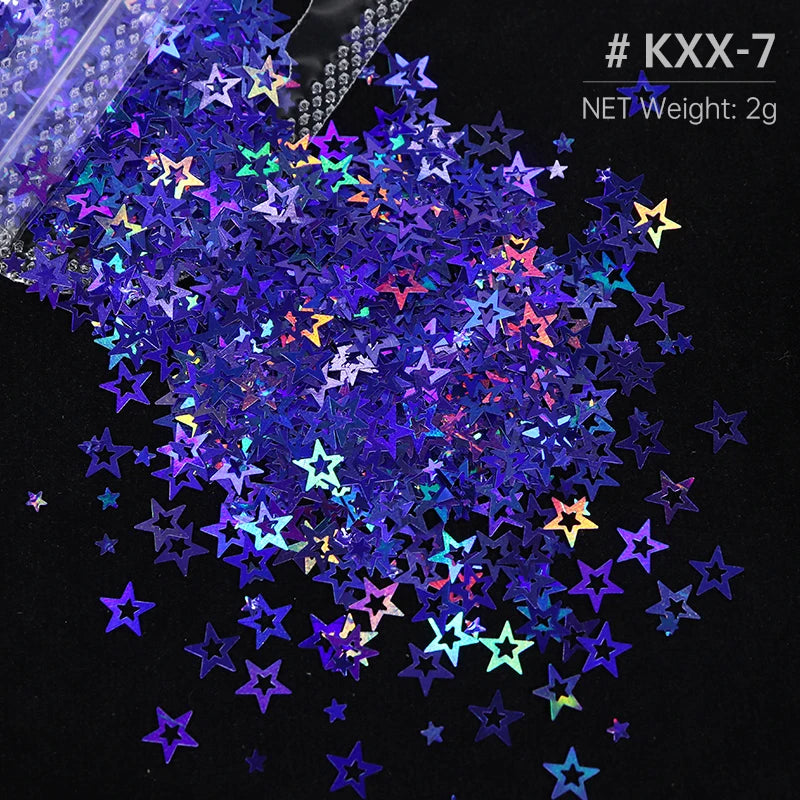 A pile of iridescent holographic star sequins in various colors scattered against a black background.