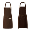 A dark brown waterproof canvas chef apron with long straps and a tie closure.