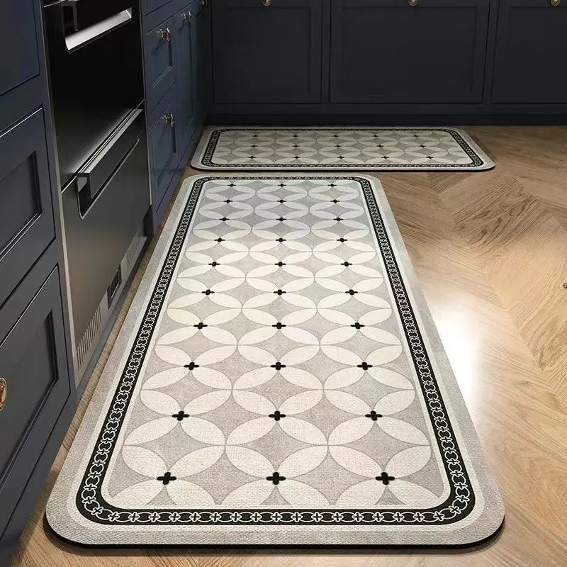 A long rectangular kitchen rug with a gray and black classic Persian pattern placed on a wooden floor.