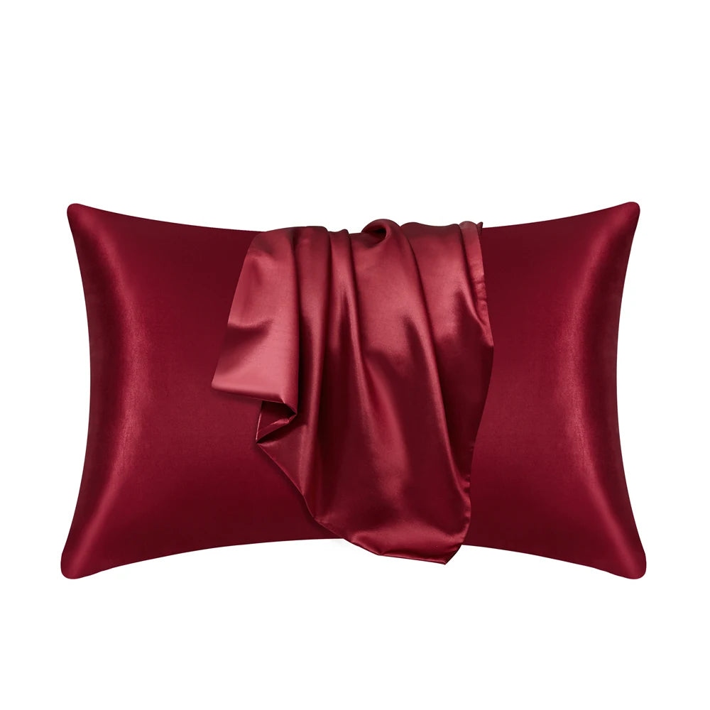 A deep burgundy silky smooth satin pillowcase rolled and displayed against a white background.