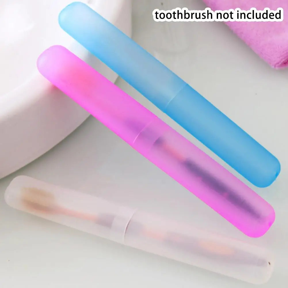 Three colored portable toothbrushes in a clear travel case on a white surface.