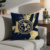 A dark blue decorative pillow featuring a gold map of North America inside a circular emblem