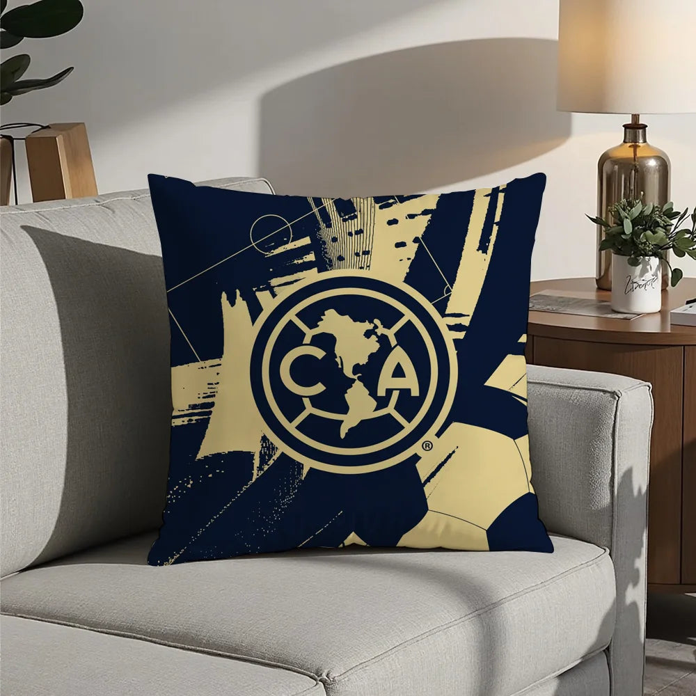A dark blue decorative pillow featuring a gold map of North America inside a circular emblem
