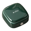 A dark green compact magnetic sewing kit with a smooth, rounded casing.