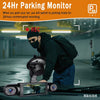 A person is installing a 24Hr Parking Monitor device onto a car's windshield.