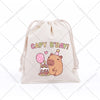 A beige drawstring storage bag featuring a cute capybara birthday design with a pink cake and party hat.
