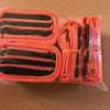 A clear plastic package containing two sets of orange and black adjustable furniture moving straps.