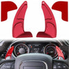 Red anodized aluminum shift paddle extenders shown in various angles and context within a car interior.