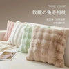 A collection of fluffy, textured decorative pillow covers in various pastel shades displayed on a white surface.