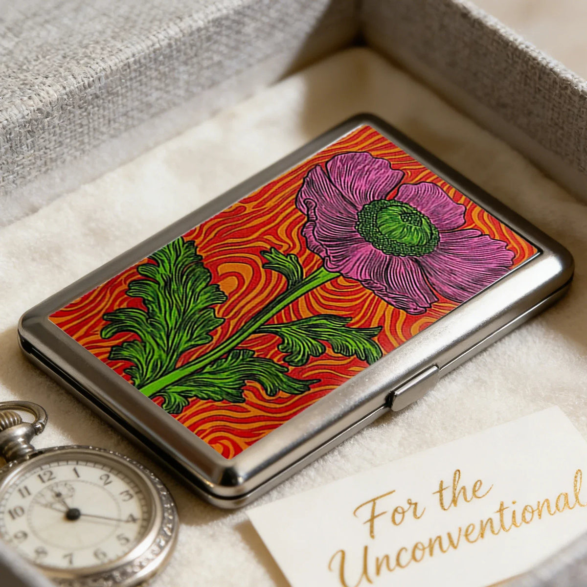 Vintage metal card and cash case with an art deco design featuring a pink flower on a red background.