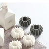 A collection of reusable laundry balls in white and gray for pet hair and lint removal.