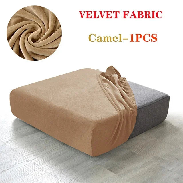 A tan velvet fabric sofa cover in a swirling pattern is shown draped over a gray sofa cushion.
