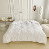 A white luxury duvet cover set with a 3D twist floral pinch-pleated pattern displayed on a bed.