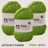 Three skeins of grass green yarn labeled Milk cot are displayed, showing the texture and color.