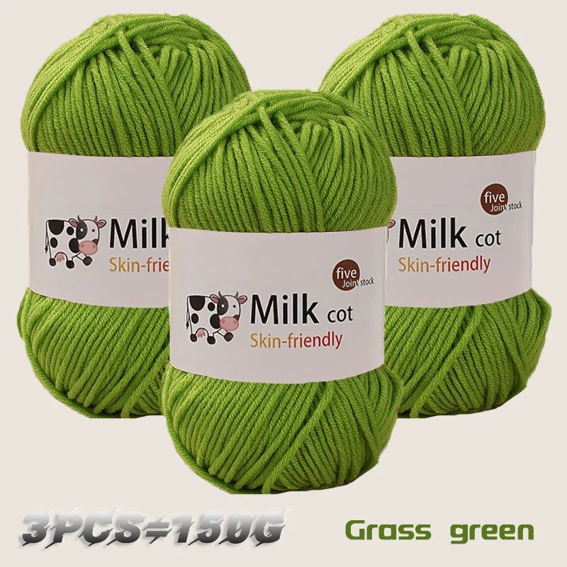 Three skeins of grass green yarn labeled Milk cot are displayed, showing the texture and color.
