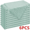 A stack of six light mint green raw-edge polyester cloth napkins.