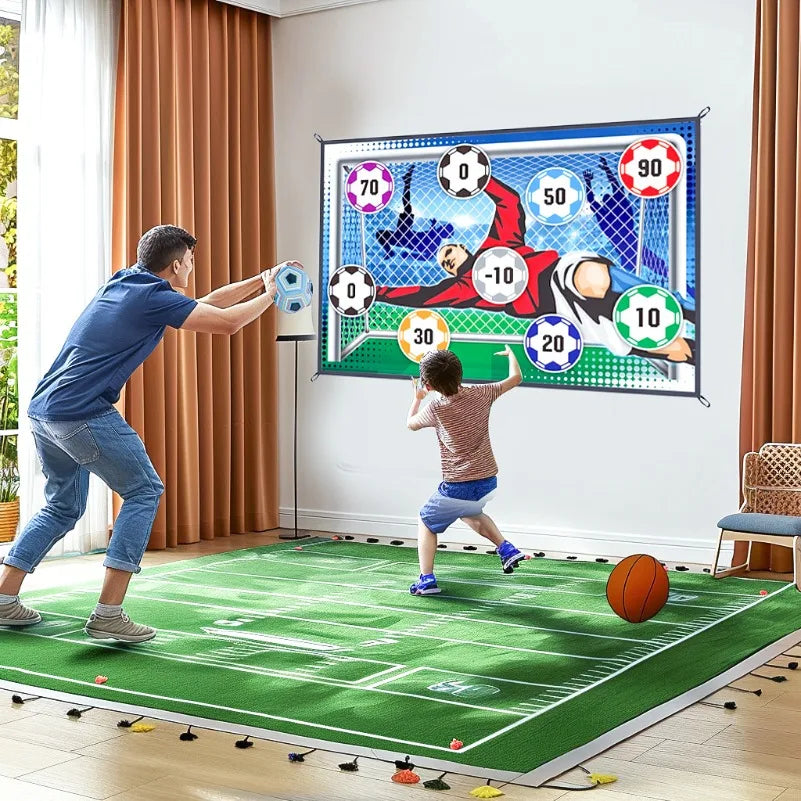 A person is playing a portable soccer target game on a green mat with a large netted target board.
