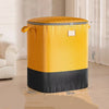 A yellow and black waterproof heavy-duty storage bag standing on a wooden floor.