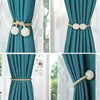Elegant pearl magnetic curtain tie-back clips in gold and white for securing drapery.