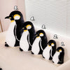 Five adorable black and white penguin plush toys lined up on a white surface.