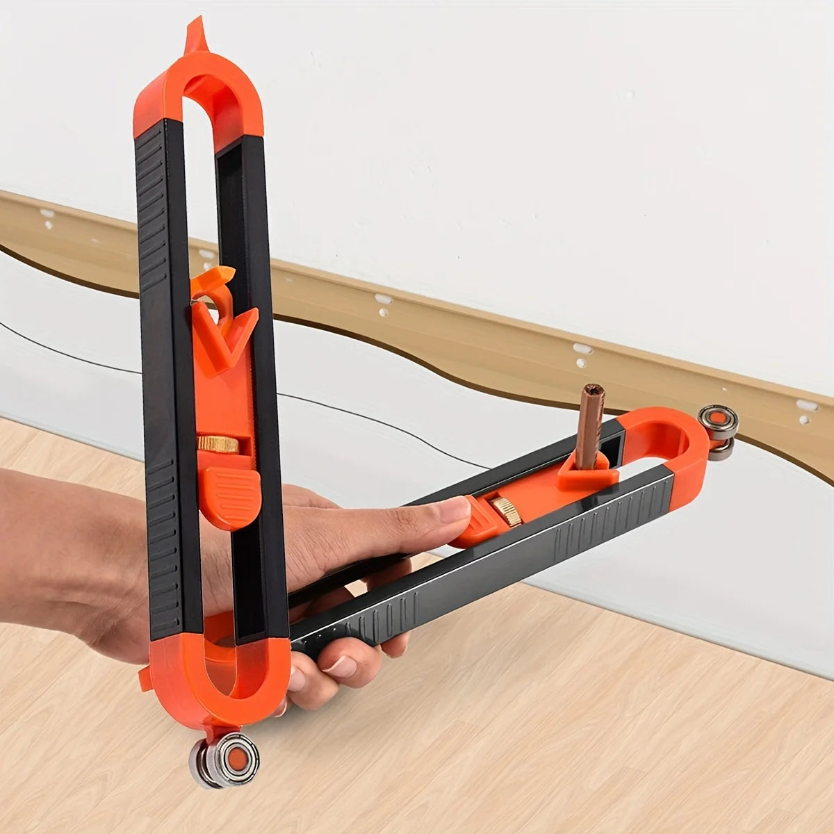 An orange contour gauge scribe tool is held by a hand, demonstrating its use for woodworking or DIY projects.