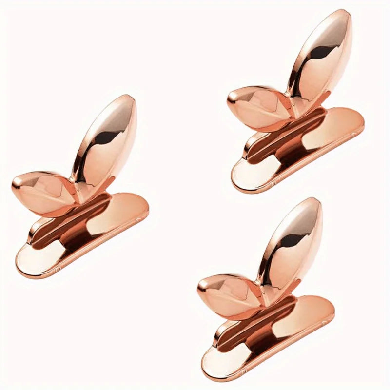 A rose gold touch-free toilet seat lifter with a flush button shown from above.