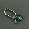 A silver D-shaped buckle keychain charm featuring a green dice with the number 13.