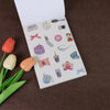 A white sticker book page filled with various fruit and letter themed stickers for scrapbooking