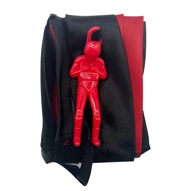 A red hand-throw parachute toy featuring a mini soldier, shown against a black and red fabric background.