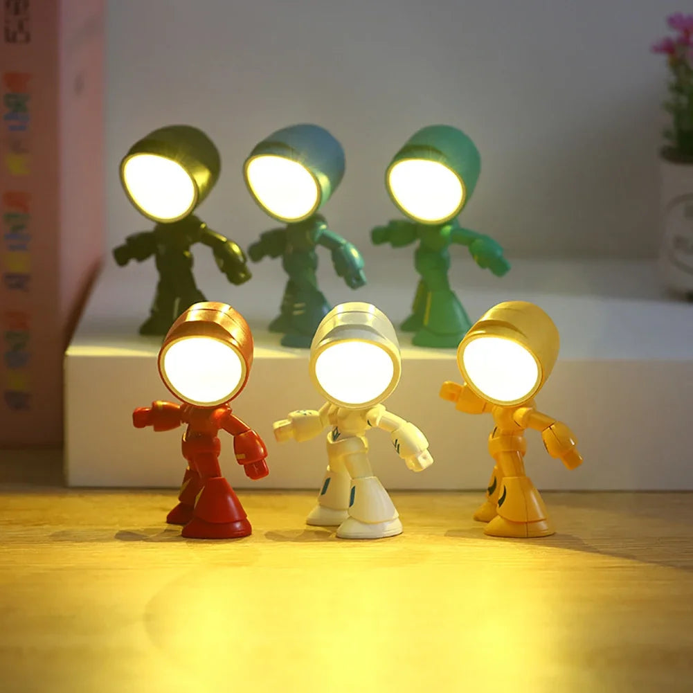 A set of three bendable robot night lights with soft glow illuminating a wooden surface.
