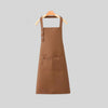 A brown canvas kitchen apron hanging on a wooden hanger.